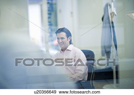 Portrait of businessman through window View Large Photo Image Stock Photo - Portrait of businessman through window. Fotosearch