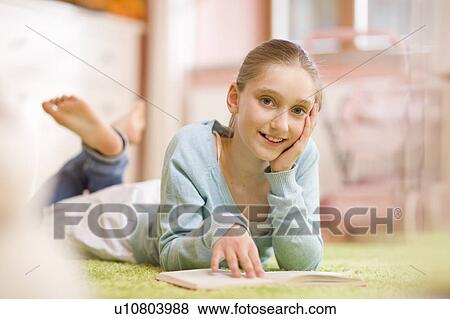 Stock Photo - Portrait of girl reading a book. Fotosearch