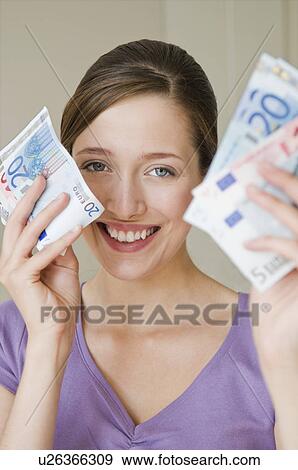 Portrait of happy woman holding money View Large Photo Image Stock Photo - Portrait of happy woman holding money. Fotosearch