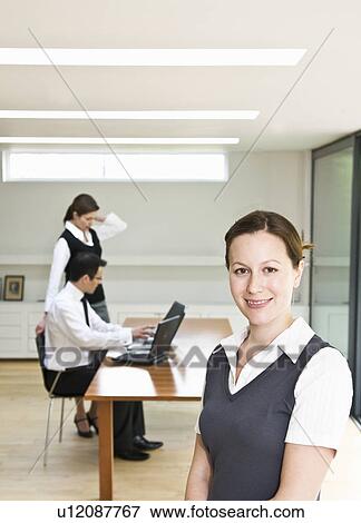 Stock Photo - Portrait of happy woman in modern office. Fotosearch