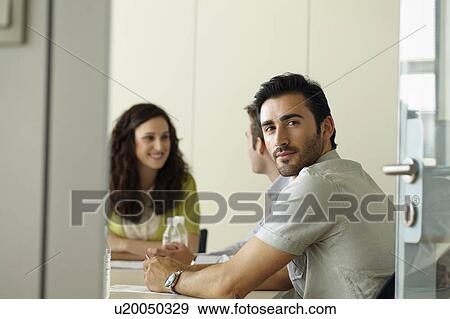 Stock Photo - Portrait of man in meeting. Fotosearch
