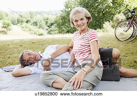Portrait of mature couple in park View Large Photo Image Stock Image - Portrait of mature couple in park. Fotosearch