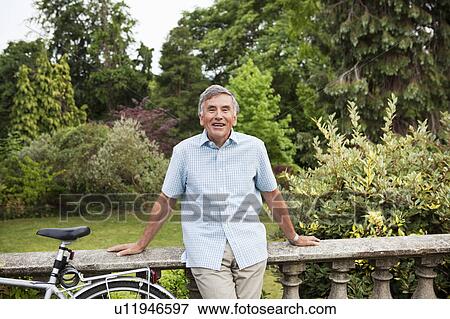 Portrait of mature man with bike View Large Photo Image Stock Photo - Portrait of mature man with bike. Fotosearch