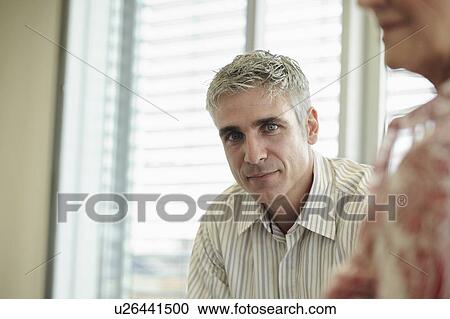 Stock Image - Portrait of middle-aged business man. Fotosearch