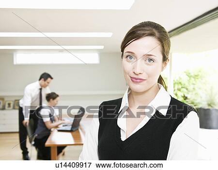 Stock Photo - Portrait of woman with colleagues. Fotosearch