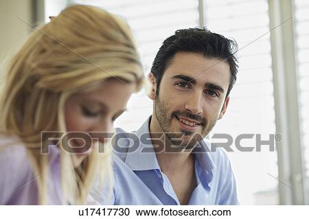 Portrait of young business man and woman View Large Photo Image Stock Image - Portrait of young business man and woman. Fotosearch
