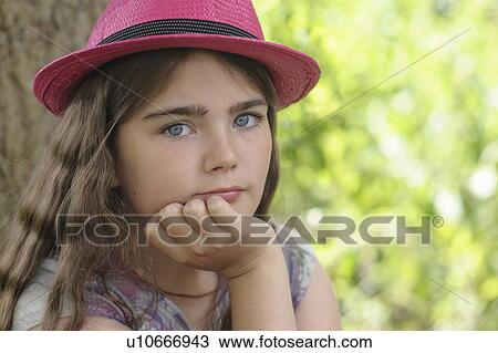 Portrait of young girl in pink hat View Large Photo Image Stock Image - Portrait of young girl in pink hat. Fotosearch
