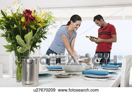 Preparing a table for a meal View Large Photo Image Stock Photo - Preparing a table for a meal. Fotosearch
