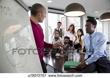 Stock Photo - Presentation during business meeting. Fotosearch
