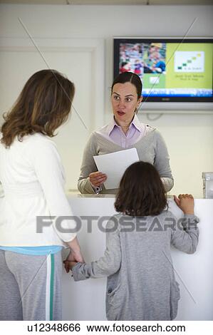 Receptionist in Doctor surgery View Large Photo Image Stock Photograph - Receptionist in Doctor surgery. Fotosearch