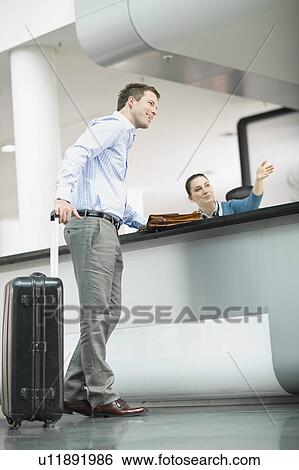 Receptionist showing the way View Large Photo Image Stock Photograph - Receptionist showing the way. Fotosearch