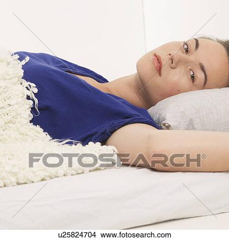 Reclined woman looking at camera View Large Photo Image Picture - Reclined woman looking at camera. Fotosearch