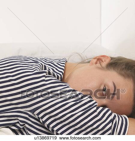 Reclined woman looking at camera View Large Photo Image Stock Photo - Reclined woman looking at camera. Fotosearch