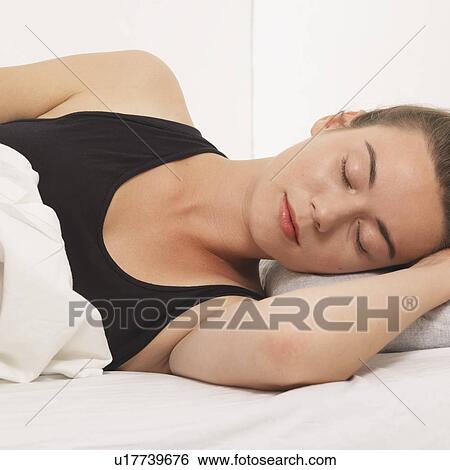 Stock Photograph - Reclined woman with her eyes closed. Fotosearch