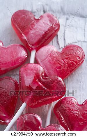 Stock Image - Red heart-shaped lollipops. Fotosearch