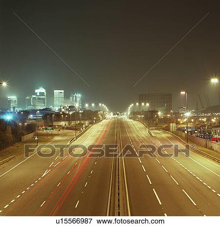 Road leading towards cityscape at night View Large Photo Image Stock Photo - Road leading towards cityscape at night. Fotosearch