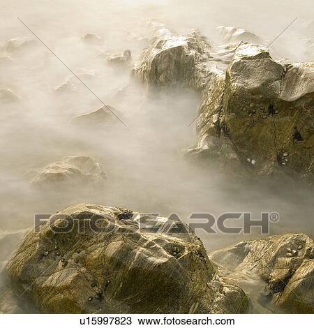 Stock Image - Rocks in sea. Fotosearch
