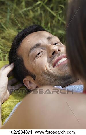 Stock Image - Romantic couple in long grass. Fotosearch