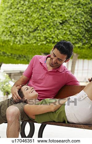 Romantic couple relaxing on bench View Large Photo Image Stock Image - Romantic couple relaxing on bench. Fotosearch