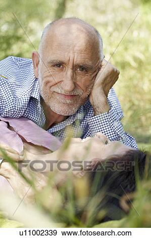 Stock Photo - Romantic older couple in long grass. Fotosearch