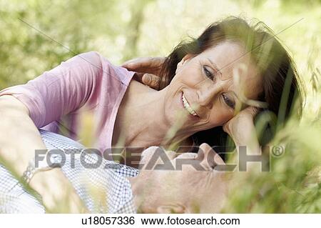 Romantic older couple in long grass View Large Photo Image Stock Photograph - Romantic older couple in long grass. Fotosearch