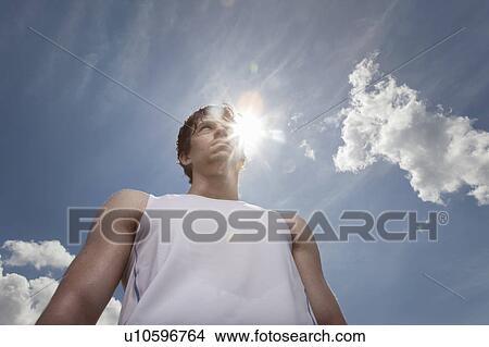 Picture - Runner photographed against the sun. Fotosearch