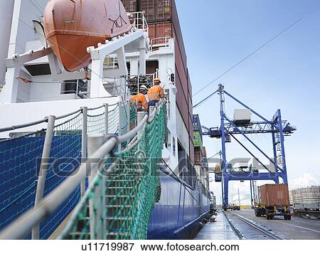 Sailors watching container ship loading View Large Photo Image Stock Photo - Sailors watching container ship loading. Fotosearch