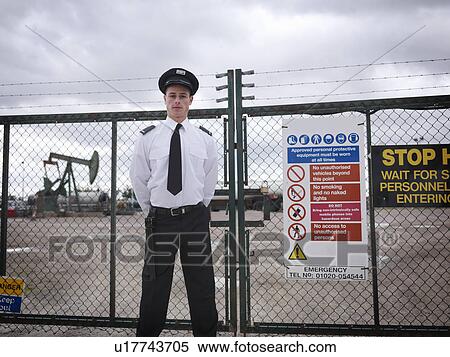 Security guard at gate of oil well View Large Photo Image Stock Photography - Security guard at gate of oil well. Fotosearch