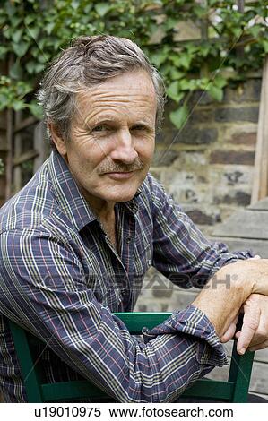 Senior Caucasian man in a garden View Large Photo Image Stock Photography - Senior Caucasian man in a garden. Fotosearch