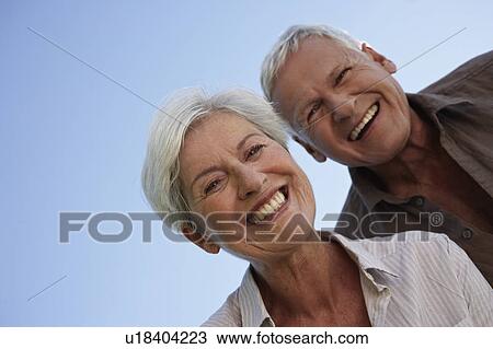 Senior couple bending over camera View Large Photo Image Stock Image - Senior couple bending over camera. Fotosearch