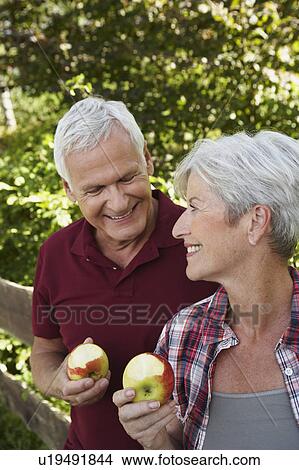 Senior couple eating apples View Large Photo Image Picture - Senior couple eating apples. Fotosearch