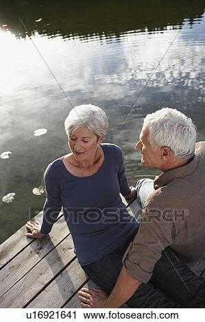 Senior couple flirting on jetty View Large Photo Image Stock Image - Senior couple flirting on jetty. Fotosearch
