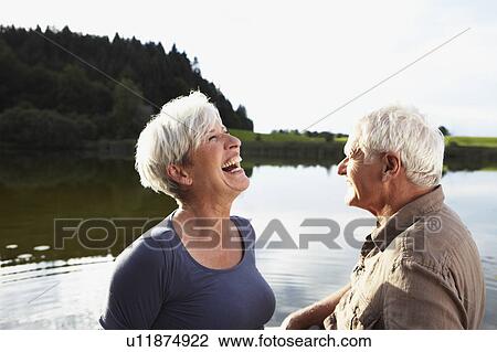 Stock Image - Senior couple having fun on lake. Fotosearch