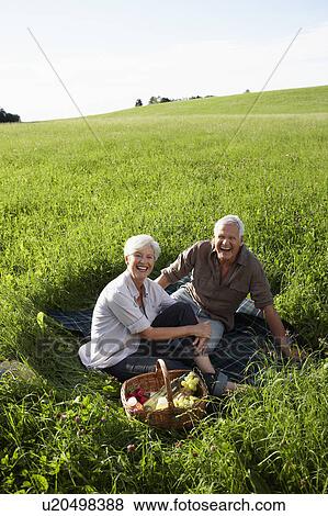 Stock Photo - Senior couple having picnic. Fotosearch