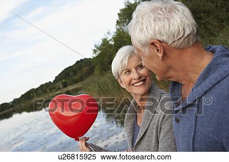 Senior couple holding red heart View Large Photo Image Stock Photography - Senior couple holding red heart. Fotosearch