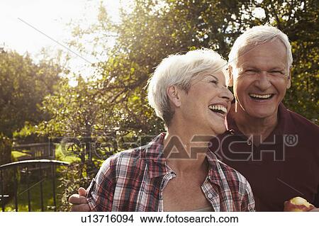 Picture - Senior couple in front of lake. Fotosearch
