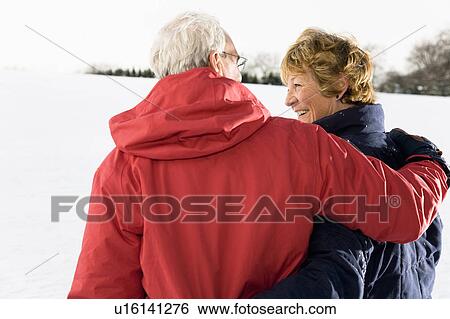 Stock Photograph - Senior couple in the snow. Fotosearch