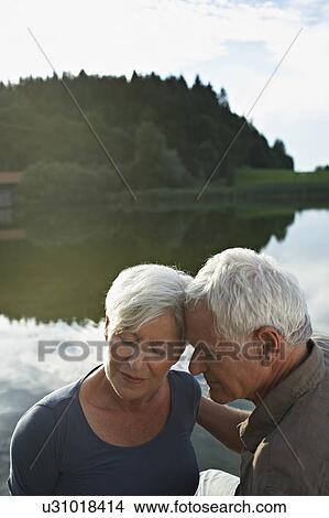 Senior couple lying heads to each other View Large Photo Image Picture - Senior couple lying heads to each other. Fotosearch