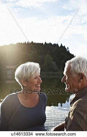 Senior couple sitting at jetty View Large Photo Image Picture - Senior couple sitting at jetty. Fotosearch