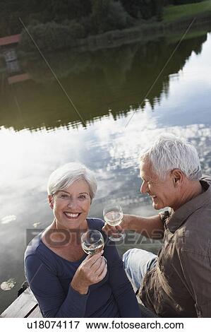 Senior couple with glasses of wine View Large Photo Image Stock Photo - Senior couple with glasses of wine. Fotosearch