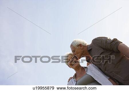 Senior man kissing woman on cheek View Large Photo Image Stock Photo - Senior man kissing woman on cheek. Fotosearch