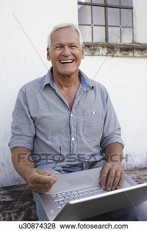 Senior man with laptop View Large Photo Image Stock Photo - Senior man with laptop. Fotosearch