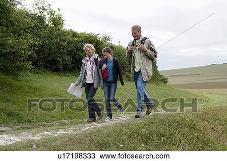 Stock Image - Seniors and grandchild on a hike. Fotosearch