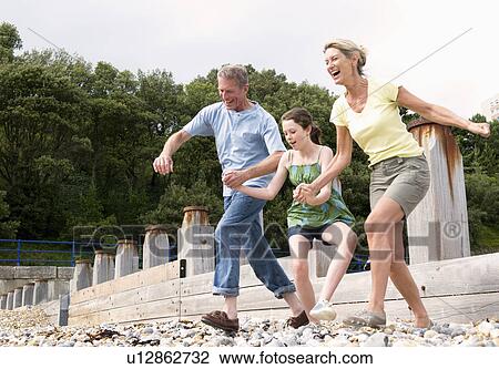 Seniors and granddaughter on beach View Large Photo Image Stock Image - Seniors and granddaughter on beach. Fotosearch