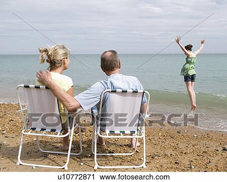 Seniors watch granddaughter on beach View Large Photo Image Stock Image - Seniors watch granddaughter on beach. Fotosearch