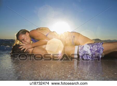 Sexy cple. kiss in tide at beach View Large Photo Image Picture - Sexy cple. kiss in tide at beach. Fotosearch
