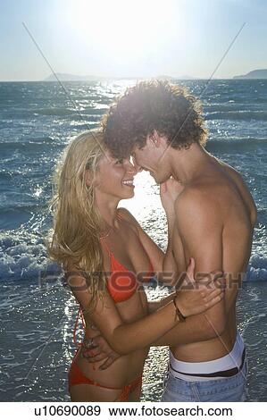 Stock Photo - Sexy cple look together by seaside. Fotosearch