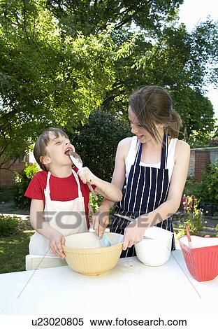 Sisters preparing cakes outdoors View Large Photo Image Stock Photography - Sisters preparing cakes outdoors. Fotosearch