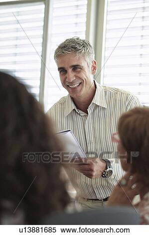 Smiling business man in discussion View Large Photo Image Stock Photography - Smiling business man in discussion. Fotosearch