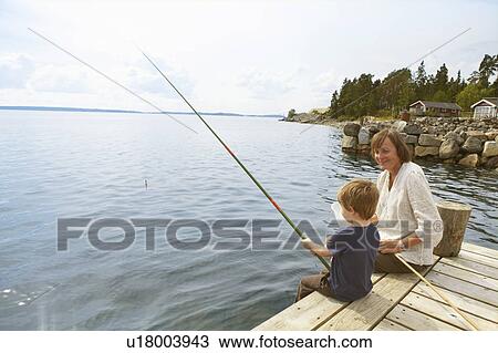 Smiling grandmother watching fishing boy View Large Photo Image Stock Image - Smiling grandmother watching fishing boy. Fotosearch